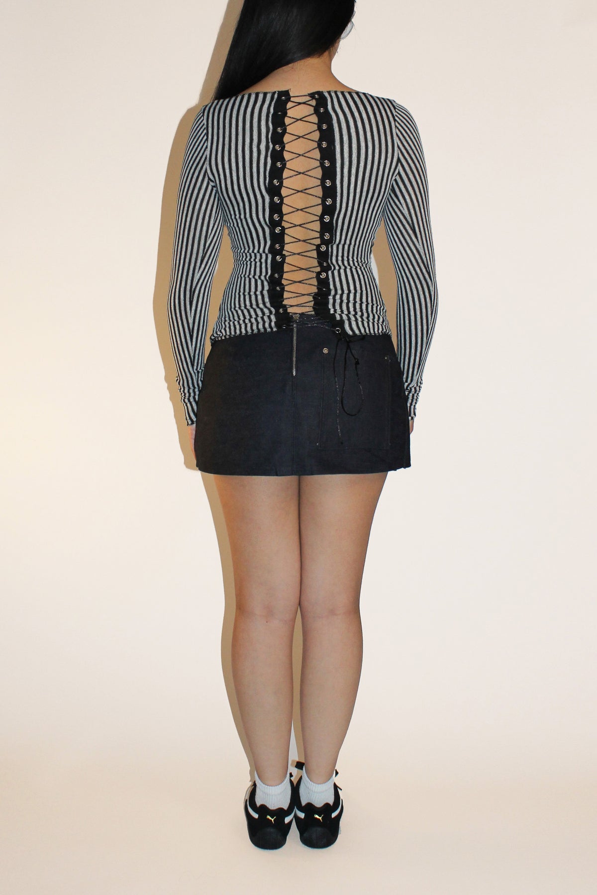 Back view of the Ivy top in stripe, showing the full grommet lace-up closure